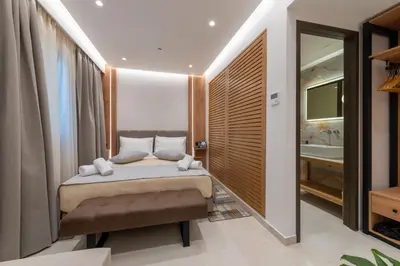 a bedroom with a bed and a bathroom at The Wine Hotel in Rhodes Town
