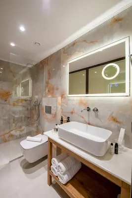 a bathroom with a sink and a toilet and a mirror at The Wine Hotel in Rhodes Town