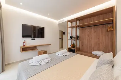 a bedroom with a large bed with towels on it at The Wine Hotel in Rhodes Town