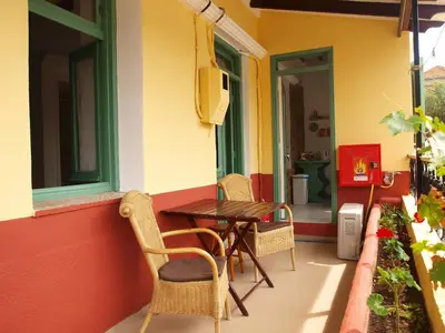 a patio with a table and chairs on a house at Marina Studios in Symi