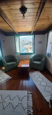 a living room with two couches and a wooden ceiling at Marina Studios in Symi