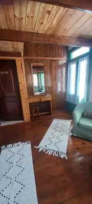 a living room with a couch and two white rugs at Marina Studios in Symi