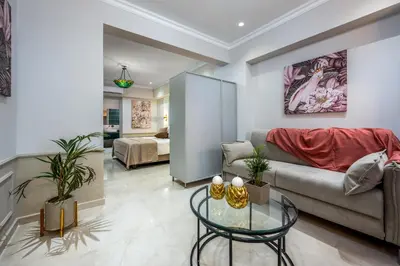 a living room with a couch and a table at Alegrand Suites in Rhodes Town