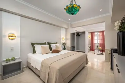 a bedroom with a large bed in a room at Alegrand Suites in Rhodes Town