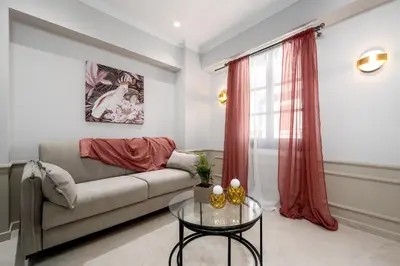 a living room with a couch and a glass table at Alegrand Suites in Rhodes Town