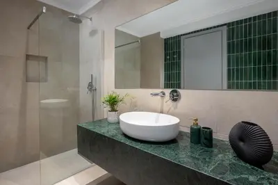 a bathroom with a sink and a shower at Alegrand Suites in Rhodes Town