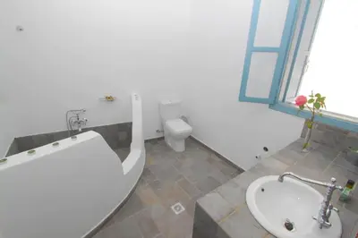 a bathroom with a tub and a toilet and a sink at Villa Polixeni Gennadi in Gennadi