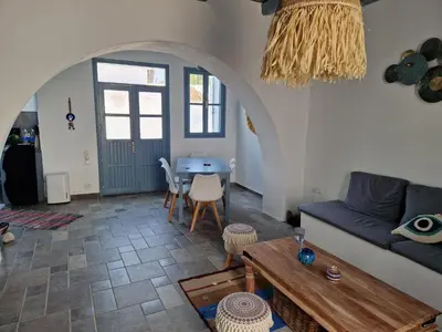 a living room with a blue couch and a table at Villa Polixeni Gennadi in Gennadi