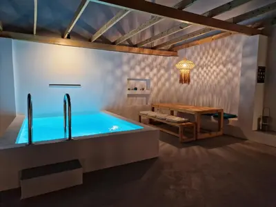 a bathroom with a bath tub and a table at Villa Polixeni Gennadi in Gennadi