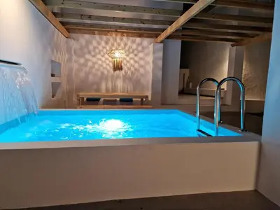 a hot tub in a room with a table at Villa Polixeni Gennadi in Gennadi