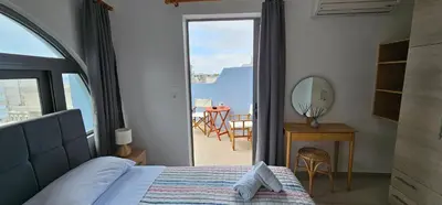 a bedroom with a bed and a view of a balcony at North Bay Apartments in Rhodes Town