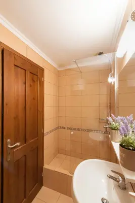 a bathroom with a shower and a sink and a toilet at Kantirimi House - A1 in Symi
