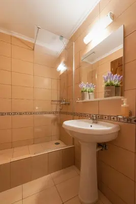 a bathroom with a sink and a mirror at Kantirimi House - A1 in Symi