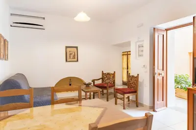 a living room with a table and chairs at Kantirimi House - A1 in Symi