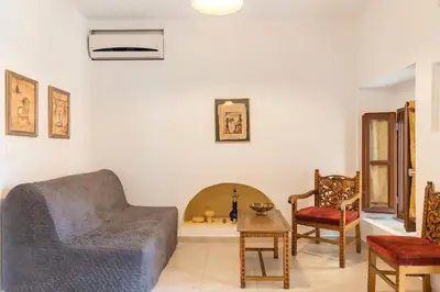 a living room with a couch and two chairs at Kantirimi House - A1 in Symi