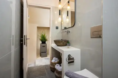 a bathroom with a sink and a mirror at Townhall Apartment in Symi