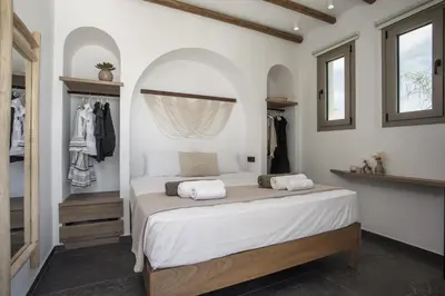 a bedroom with a bed with two towels on it at CasaCarma V, privates XL-Pool, Boho-Design in Lachania