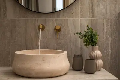 a bathroom with a large concrete sink and a mirror at CasaCarma V, privates XL-Pool, Boho-Design in Lachania