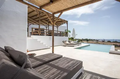 a patio with a couch and a swimming pool at CasaCarma V, privates XL-Pool, Boho-Design in Lachania