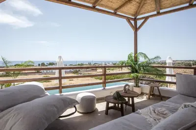 a living room with a view of the ocean at CasaCarma V, privates XL-Pool, Boho-Design in Lachania