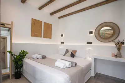 a white bedroom with a bed with towels on it at CasaCarma IV, private XL Pool, Boho-Design in Lachania
