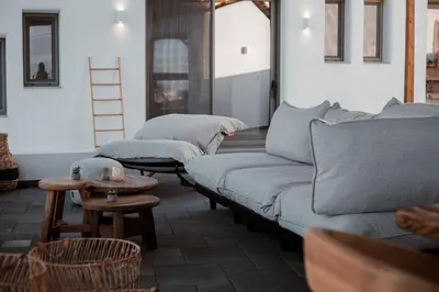 a row of couches in a room with a table at CasaCarma IV, private XL Pool, Boho-Design in Lachania