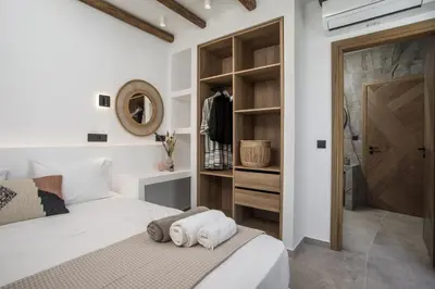 a bedroom with a bed and a walk in closet at CasaCarma IV, private XL Pool, Boho-Design in Lachania