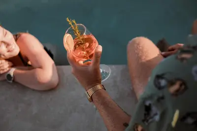 a person holding up a glass with food in it at CasaCarma IV, private XL Pool, Boho-Design in Lachania