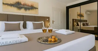 a hotel room with two beds with glasses of wine at Villa Small Paradise private pool, jacuzzi, BBQ, complete privacy in Ialyssos
