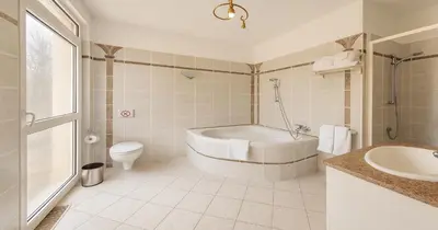 a bathroom with a tub and a toilet and a sink at Villa Small Paradise private pool, jacuzzi, BBQ, complete privacy in Ialyssos