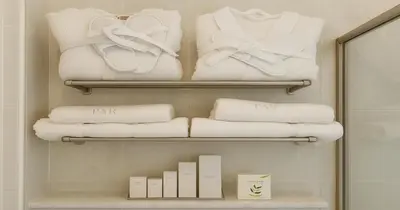 a closet with white towels and a pile of towels at Villa Small Paradise private pool, jacuzzi, BBQ, complete privacy in Ialyssos