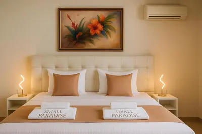 a bedroom with a large bed with two white pillows at Villa Small Paradise private pool, jacuzzi, BBQ, complete privacy in Ialyssos