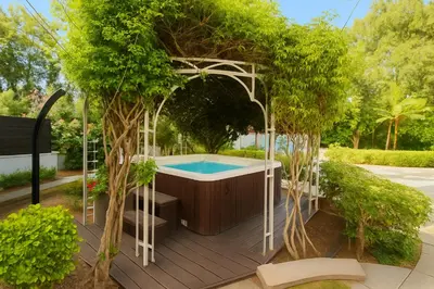 a hot tub in a gazebo with trees at Villa Small Paradise private pool, jacuzzi, BBQ, complete privacy in Ialyssos