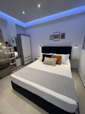 a bedroom with a large bed with a blue ceiling at Ikarus Rhodes Center in Rhodes Town