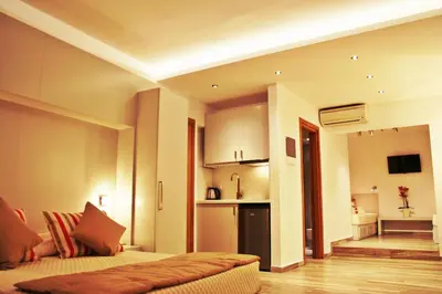 a living room with a bed and a kitchen at Lindos Beauty in Líndos
