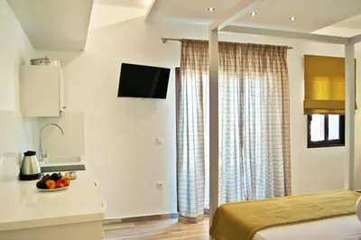 a bedroom with a bed and a bowl of fruit on a table at Lindos Beauty in Líndos