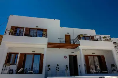 a white building with two balconies on top of it at Lindos Beauty in Líndos