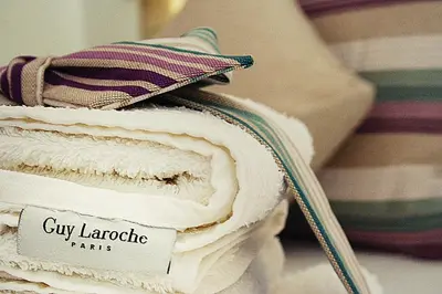 a stack of towels with a sign on them at Lindos Beauty in Líndos