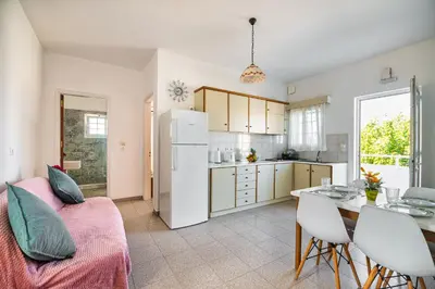 a kitchen and dining room with a white refrigerator at Nikolas Apartment in Pefki Rhodes