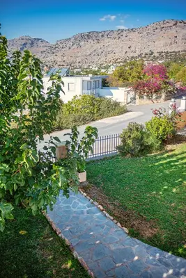 a stone walkway in a yard with a house at Nikolas Apartment in Pefki Rhodes