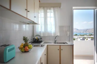 a kitchen with a sink and a bowl of fruit on the counter at Nikolas Apartment in Pefki Rhodes