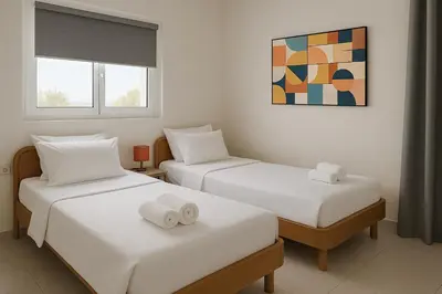 a bedroom with two beds with towels on them at Aegean Helios Houses in Gennadi