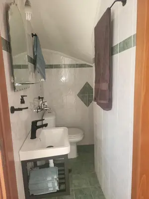 a small bathroom with a sink and a toilet at Aegean Helios Houses in Gennadi