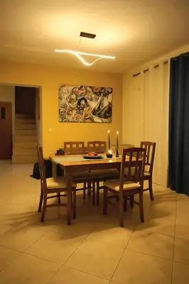 a dining room with a wooden table and chairs at Aegean Helios Houses in Gennadi