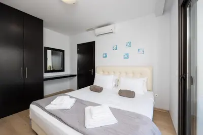 a bedroom with a white bed with towels on it at Villa Dias in Lachania