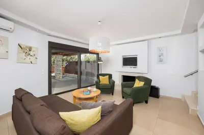 a living room with a couch and two chairs at Villa Dias in Lachania