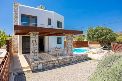 a villa with a swimming pool and a house at Villa Dias in Lachania