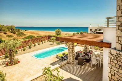 an image of a villa with a swimming pool and the ocean at Villa Dias in Lachania