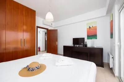 a hat sitting on a bed in a room at Villa Pelagos Blue in Yennadhion