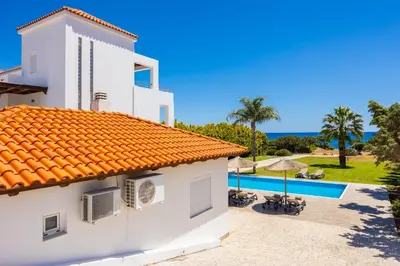 a villa with a view of the swimming pool at Villa Pelagos Blue in Yennadhion